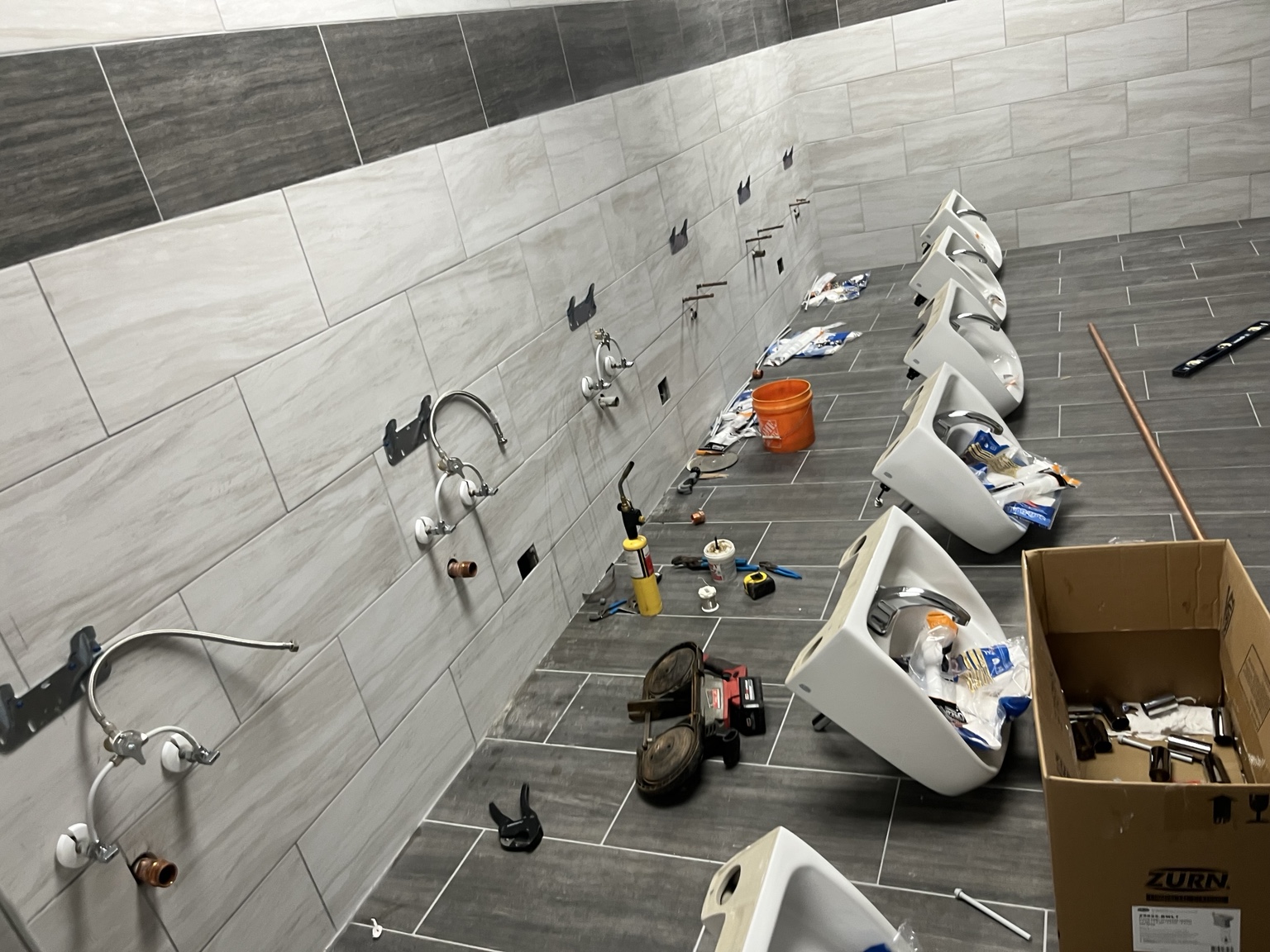 Commercial restroom fixture installation by DHS Plumbing, view 1